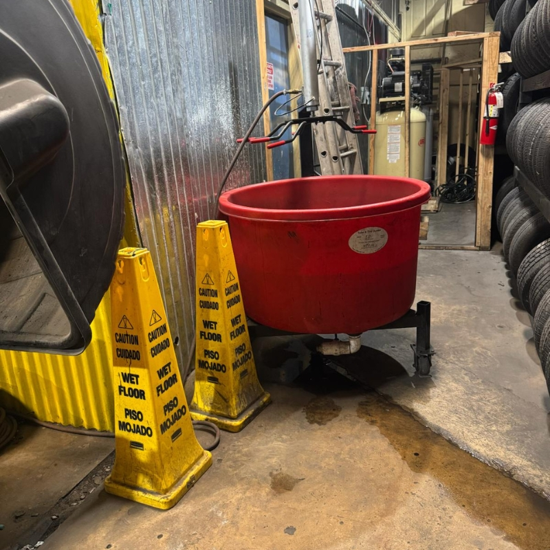 Clean shop floor with tire prep station and safety signage