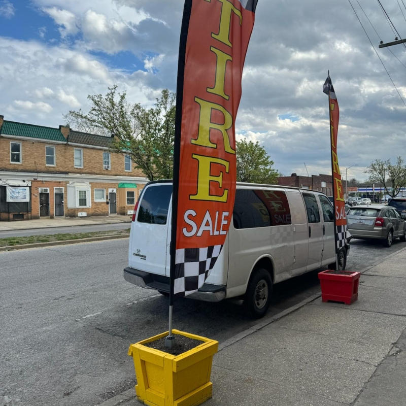 Tire Sale flags outside the Belvedere Ave shop