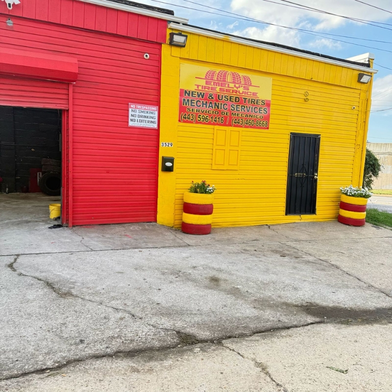 Front facade of the Hanover St location with Emely's Tire Service signage