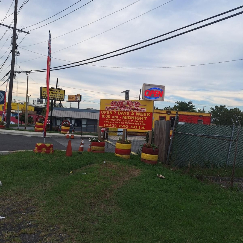 Roadside signage at Emely's Tire Service North Point Blvd location